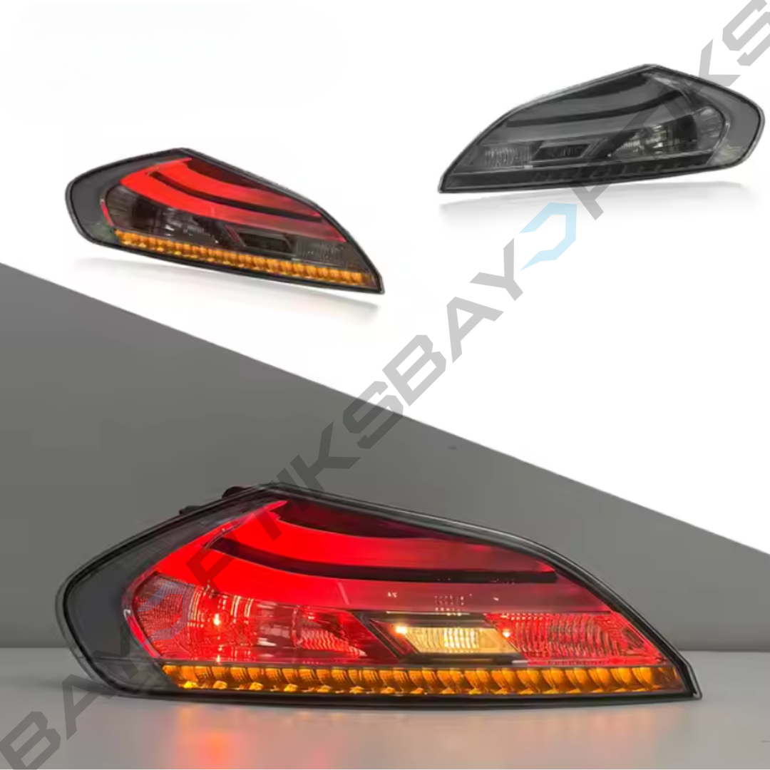 Car tail lights with red and orange lenses on a gray background